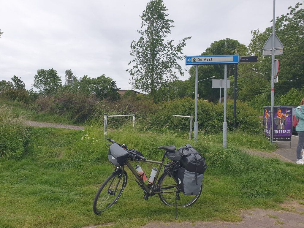 My touring bike in front of a sign of camping De Vest